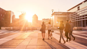Shot of a group of well-dressed businesspeople walking through the city during the day